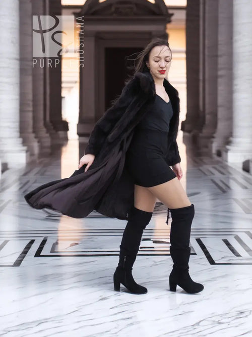 Mink fur coat with draped tie detail, dark color, standing pose
