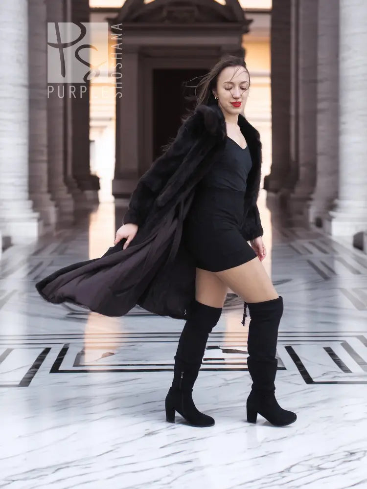 Mink fur coat with draped tie detail, dark color, standing pose