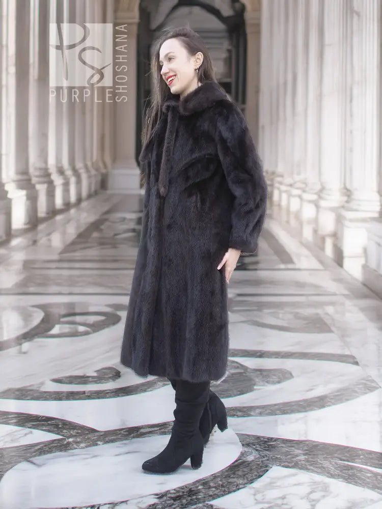 Dark mink fur coat with tie waist, long sleeves, stand collar.