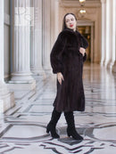 Dark mink fur coat with stand collar and voluminous sleeves, mid-calf length.
