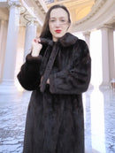 Mink fur coat with oversized collar, tie belt at waist, long sleeves and textured fur