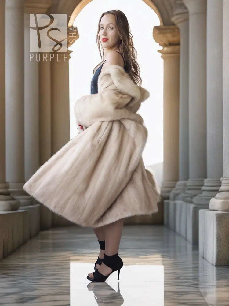Golden Pearl mink fur coat with shawl collar, cream tone, flared mid-length hem.