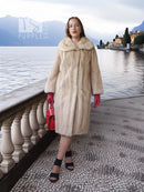 Golden Pearl mink fur coat with shawl collar, cream tone, mid-length hem.