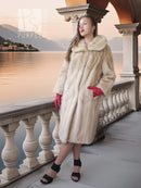 Golden pearl mink fur coat in light cream with wide fur collar and knee length.