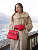 Golden pearl mink fur coat in light cream, mid-calf length, with wide fur collar.