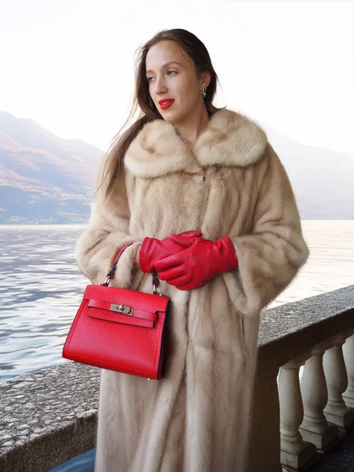 Golden pearl mink fur coat in light cream, mid-calf length, with wide fur collar.