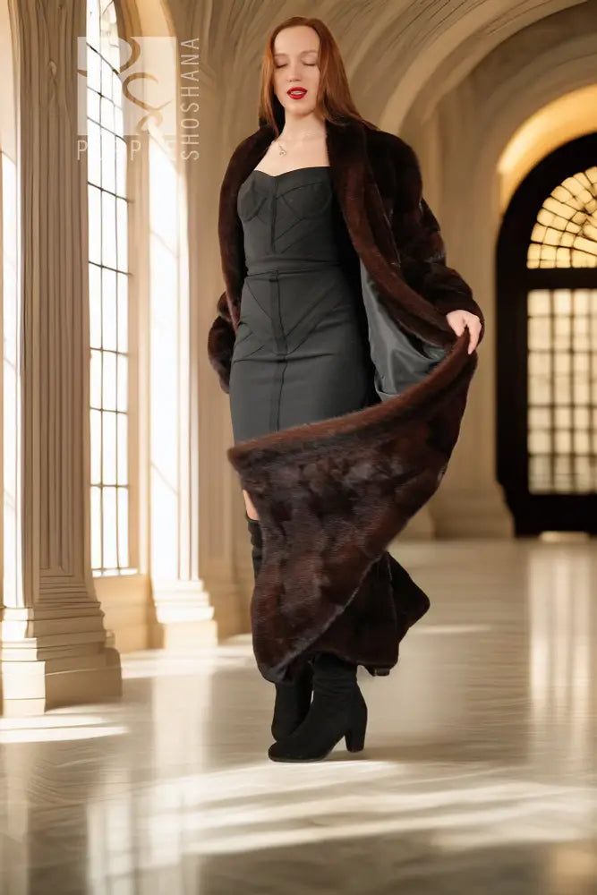 Reversible mink coat shown with dark brown fur exterior and black lining at cuffs.