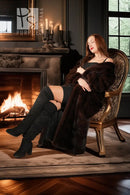 Dark brown reversible mink coat draped over shoulders, long length and open front.