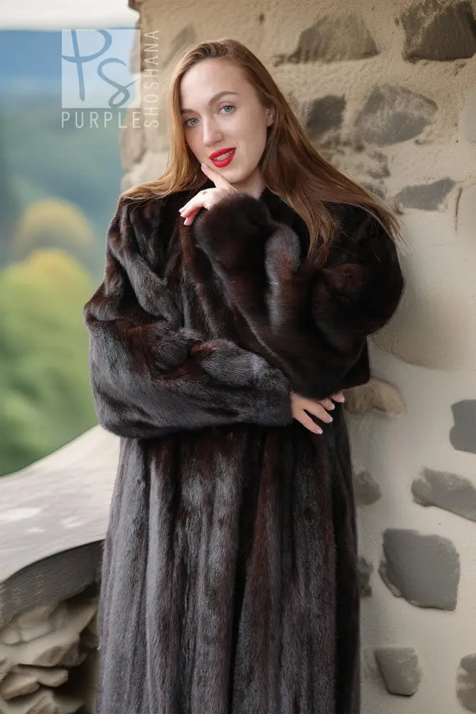 Black mink fur coat with thick fur texture and a high, wrap-like collar