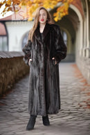 Long black mink fur coat with draped cuffs and a straight, floor-length hem