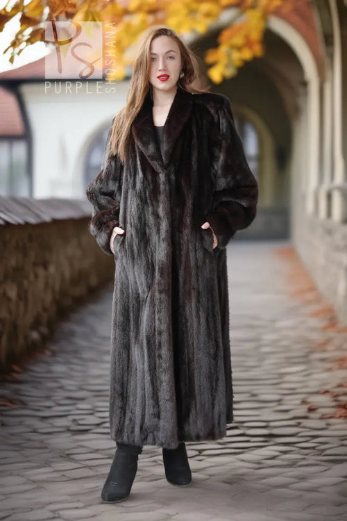 Long black mink fur coat with draped cuffs and a straight, floor-length hem