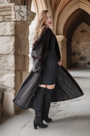 Long black mink fur coat with a swingy open front over dark pants