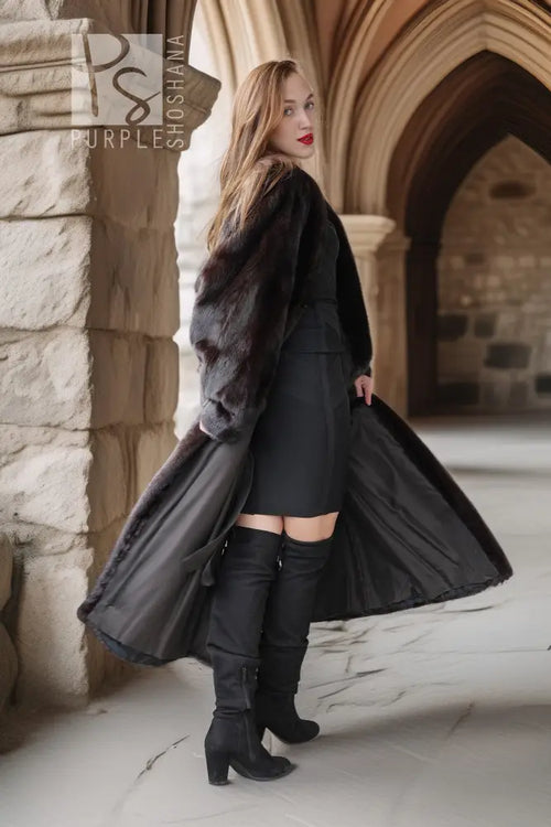 Long black mink fur coat with a swingy open front over dark pants