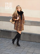 Leopard-pattern fur coat with black fox-fur collar and voluminous sleeves, worn with boots