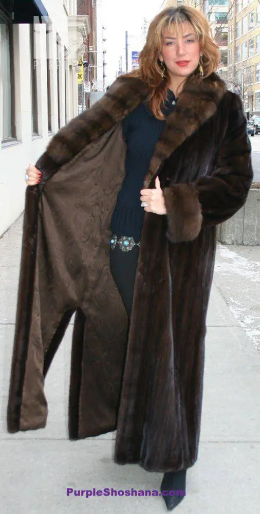Women’s dark brown mink fur coat with wide collar and open front, full length.