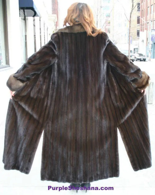 Women’s dark brown mink fur coat, back view, wide shoulders and flared sleeve cuffs.