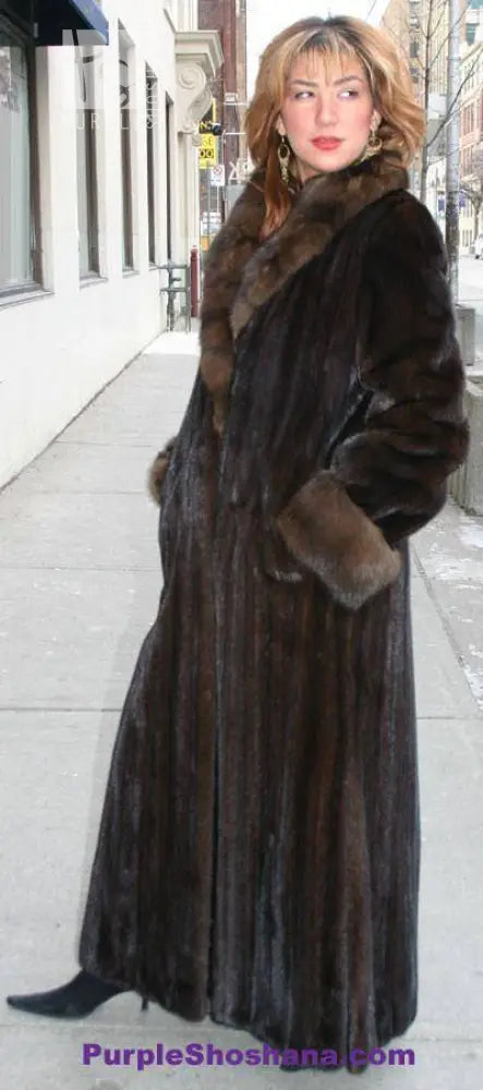 Women’s dark brown mink fur coat with broad fur collar and full sleeves, side view.