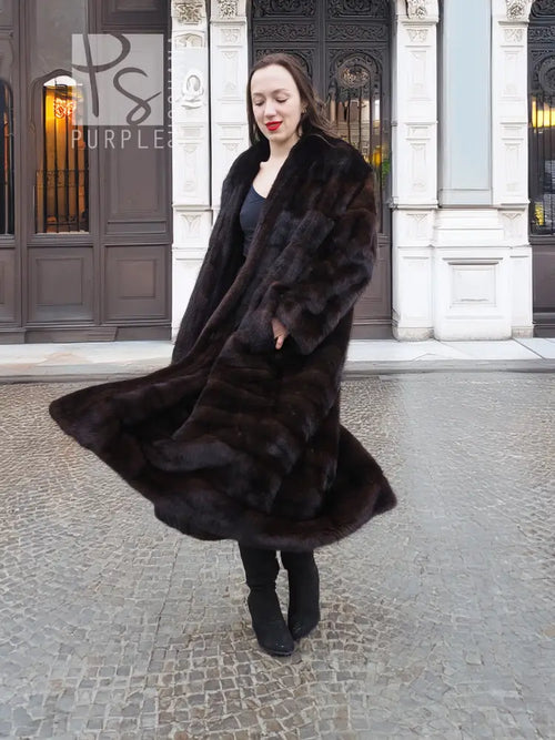 Dark mink fur coat with wide shawl collar and tiered horizontal fur bands