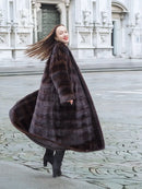 Dark brown mink fur coat shown from the side, with horizontal stripe panels