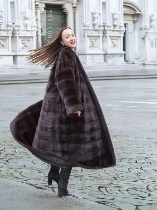 Dark brown mink fur coat shown from the side, with horizontal stripe panels