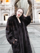 Dark brown mink fur tuxedo coat with wide collar and horizontal fur stripe panels