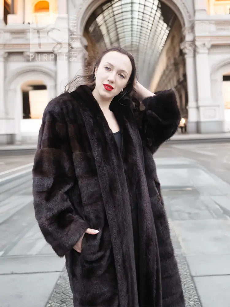 Dark brown mink fur tuxedo coat with wide collar and horizontal fur stripe panels