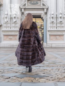 Dark brown mink fur coat from the back with horizontal stripe pattern and long hem