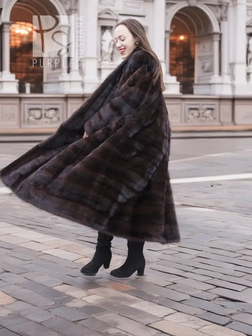 Dark brown mink fur coat with horizontal stripe texture, flowing long hem