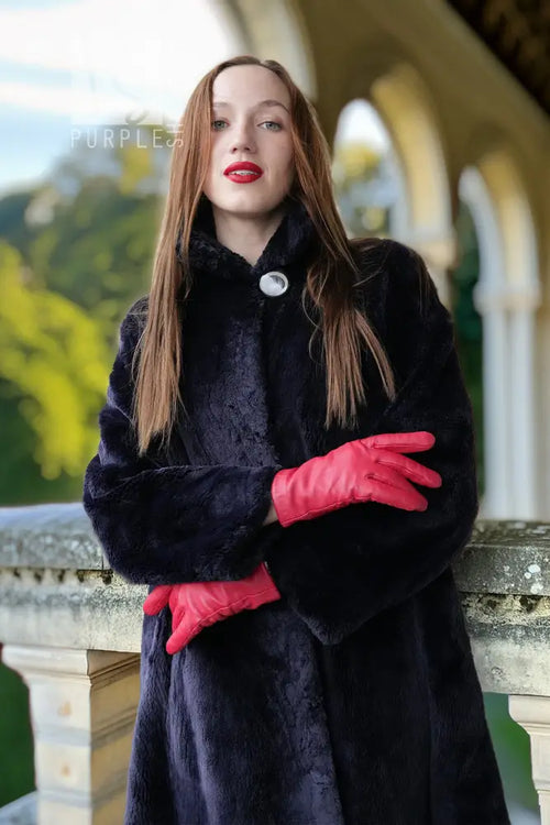 Midnight Iris coat close-up: dark navy sheared beaver, hood and round silver button