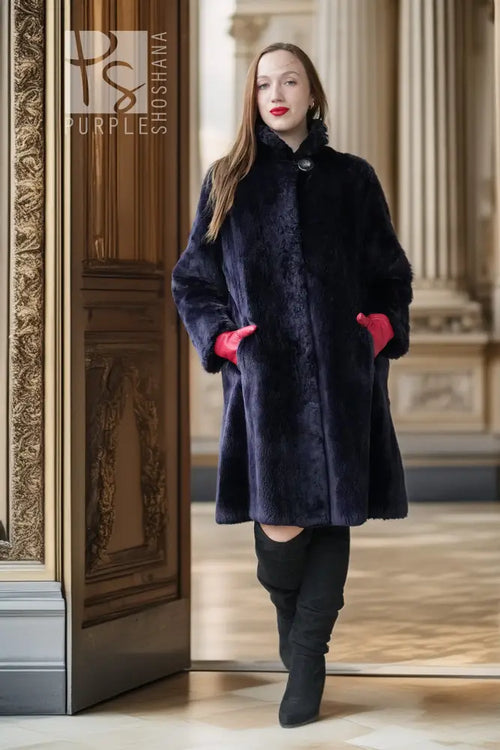 Front view of "Midnight Iris" sheared beaver coat, navy, snap closure, red inner cuffs