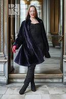 Sheared beaver coat in navy with open front, red-lined cuffs, midi-length flare hem