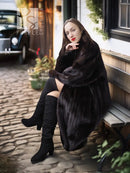 Black mink coat with stand collar, relaxed fit, and long sleeves