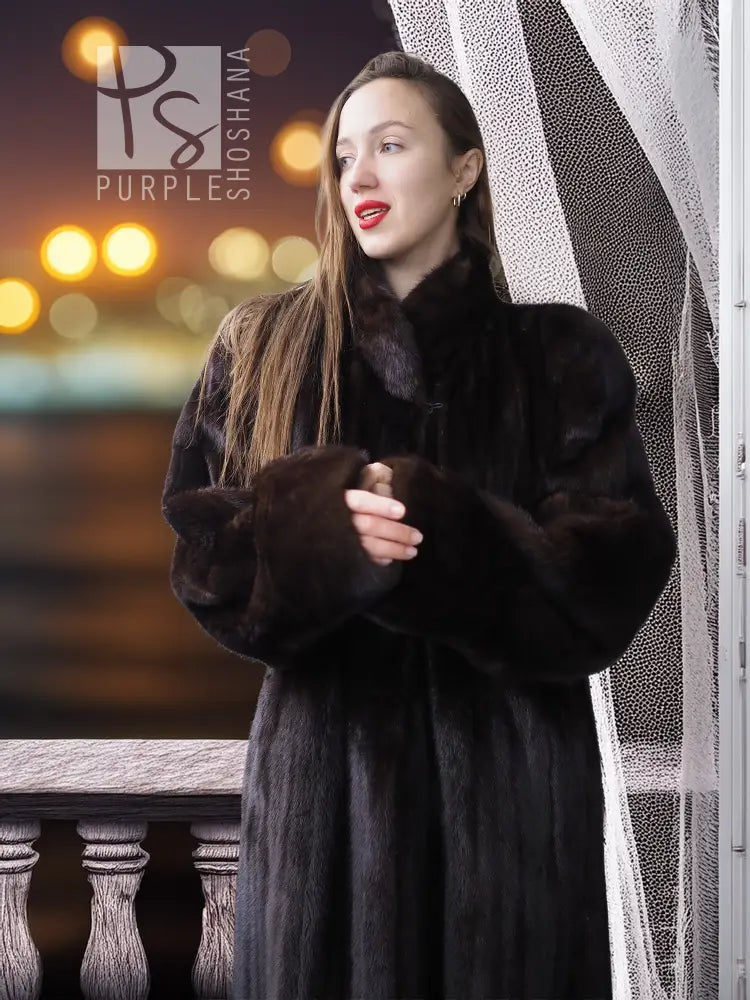 Black mink coat with textured sleeves and high rounded collar