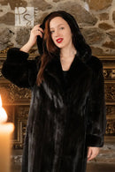 Black hooded mink coat with soft textured fur, close-up with hood up