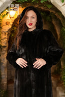 Black hooded mink coat close-up, plush texture, buttoned front and hood