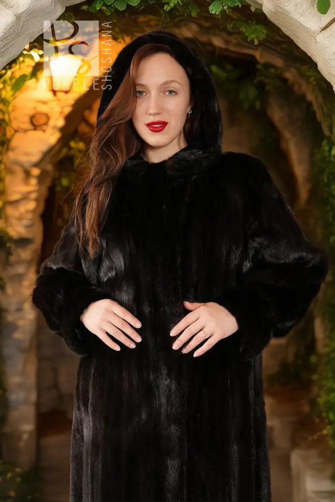 Black hooded mink coat close-up, plush texture, buttoned front and hood