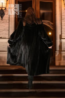 Back view of black hooded mink coat with full sleeves and long hem