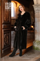Black hooded mink coat in doorway setting, long length, button closure