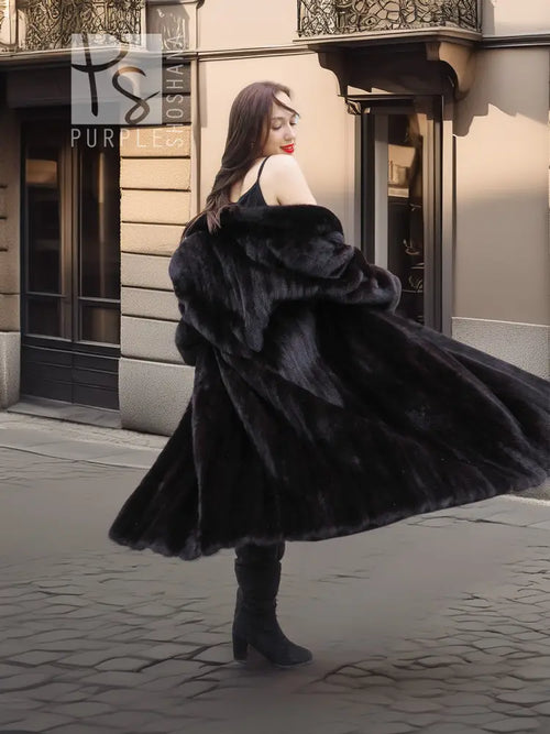 Black mink coat with fur hood and flared skirt hem, back view