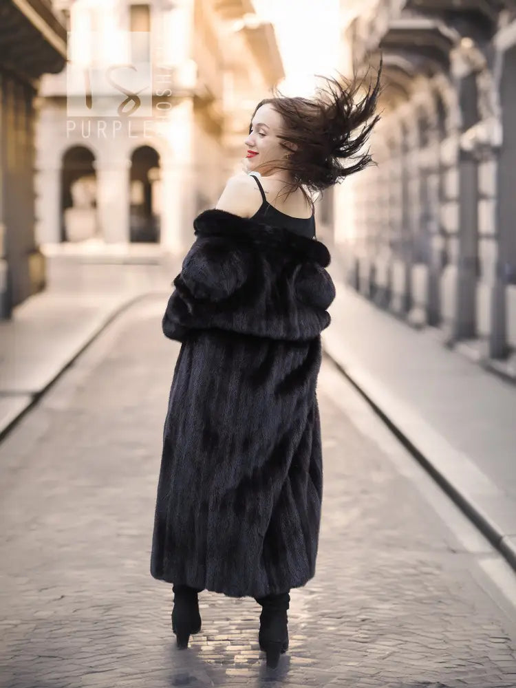 Black mink fur coat with layered off-shoulder collar, front walking view