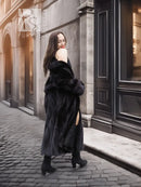 Black mink coat with hood and wide collar, side view with open back hem