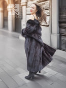 Black mink fur long coat with high collar and flowing hem, back three-quarter stance.