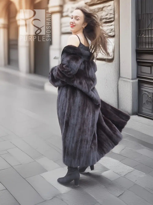 Black mink fur long coat with high collar and flowing hem, back three-quarter stance.