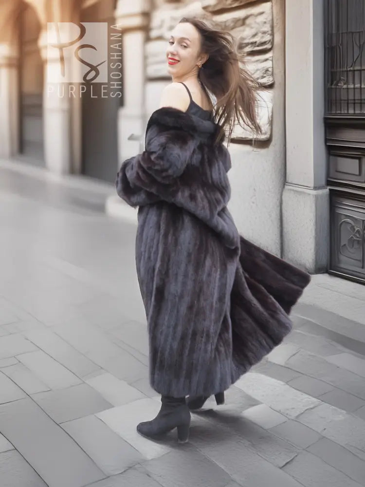 Black mink fur long coat with high collar and flowing hem, back three-quarter stance.