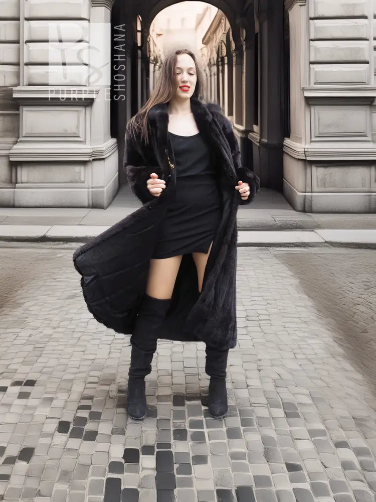 Black mink fur coat worn over black dress, long hem and plush fur collar.