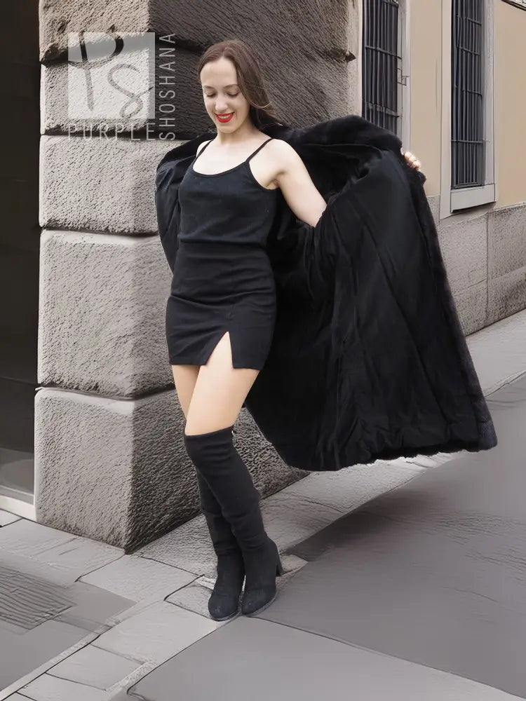 Black mink fur coat with off-shoulder silhouette and long sleeves, side view over dress