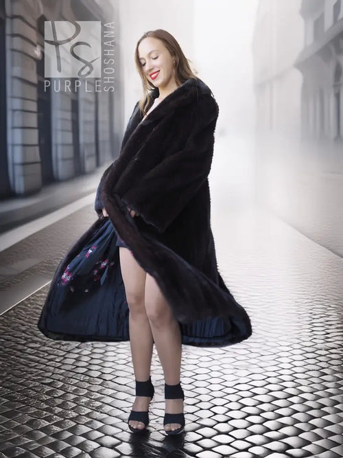 Black mink coat, long A-line silhouette with wide fur sleeves and slit hem