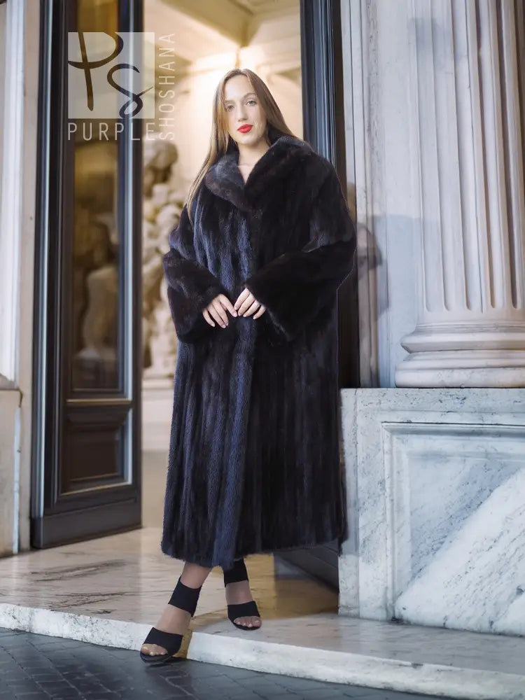 Black mink coat, long length with belt tie at waist and open front, standing