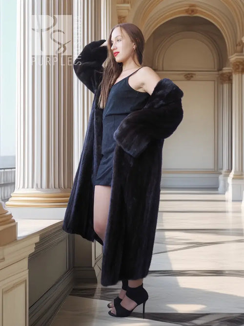 Black mink coat with defined shoulders and open front, side pose