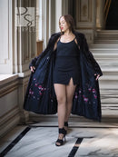 Black mink coat, long mid-calf length with open front and floral-lined inner hem.